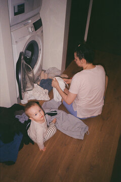 Mother and Child Doing Laundry at Home. Everyday Chores - film analog