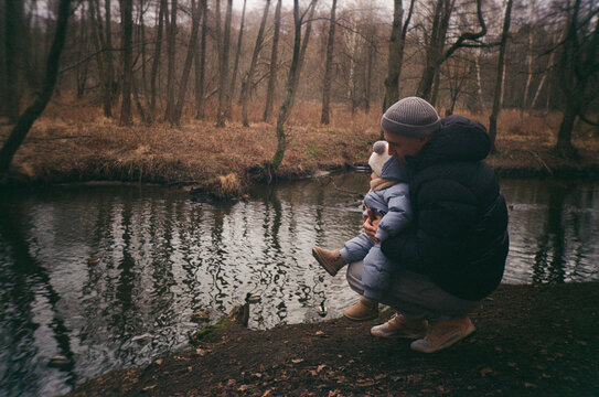 Father and Child by the River Feeding Ducks  - film analog