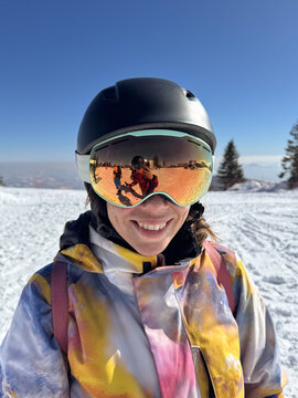 Happy Female Skier With Reflective Orange Ski Goggles