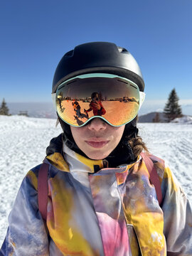Happy Female Skier With Reflective Orange Ski Goggles