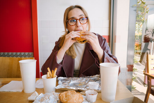 Woman biting into a burger