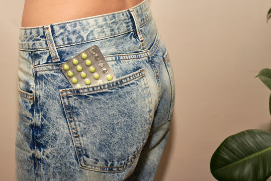 Woman having blister of pills in her back pocket
