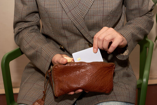 Woman pulls сredit card from wallet