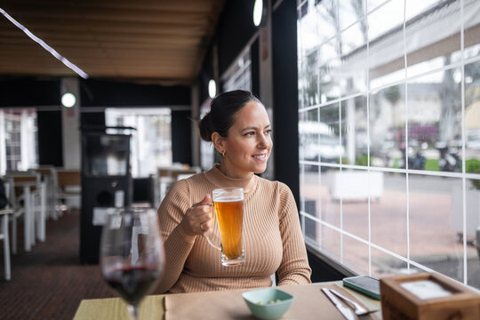 woman drinking beer in a restaurant