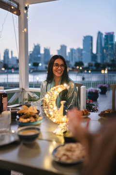Woman Sharing Iftar Meal at Sunset
