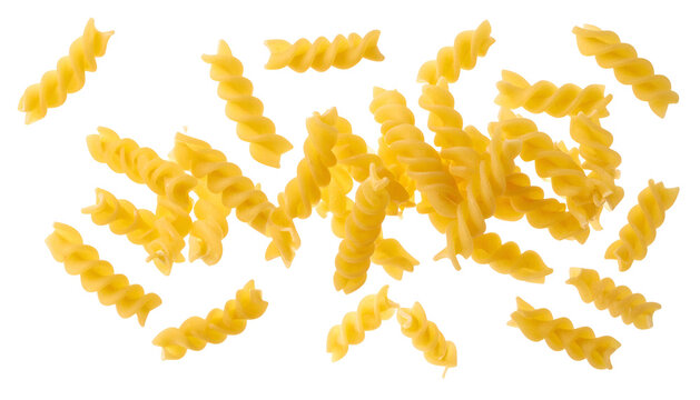 Close-up of uncooked fusilli pasta spirals, scattered on a black background, top-down view