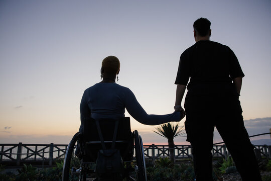 Friends Supporting Each Other at Sunset by the Waterfront