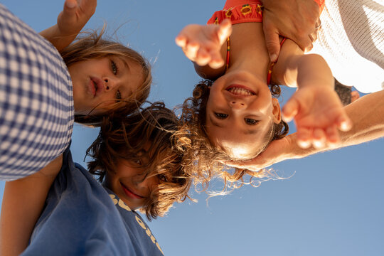 Kids standing above my camera and looking in my lens.