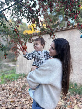 Mother and daughter Enjoy playing with christmas tree