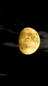 Full Golden Moon Shines Brightly In Dark Night Sky With Wispy Clouds And Distant Stars Celestial Body Glowing With