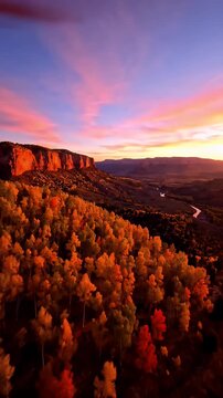 Golden Autumn Forest and River Valley at Sunset with Vibrant Orange and Pink Sky and Canyon Cliffs
