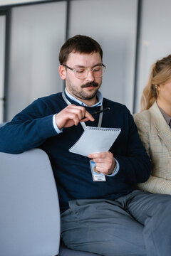 A man writes in a notebook