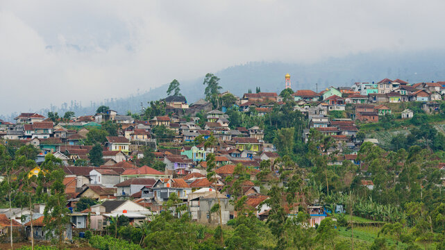 Hillside village in Pasirwangi, Garut, Indonesia. Aerial-style view showing traditional settlements integrated into a mountain landscape. Authentic West Java travel and rural architecture.
