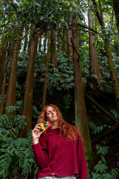 Woman with disposable camera in forest
