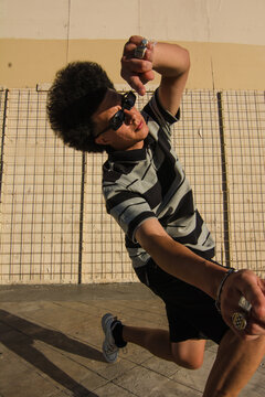 Wide angle portrait of urban dancer wearing sunglasses