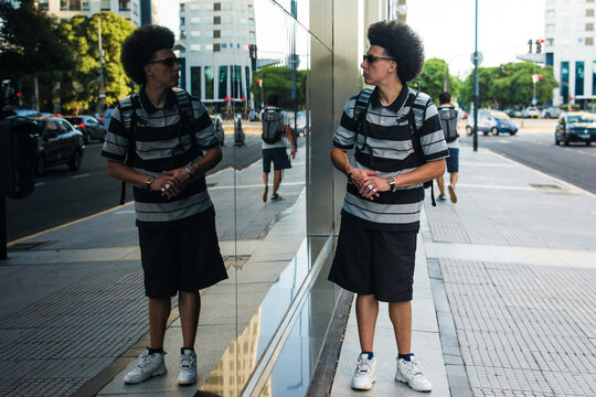Man watching himself in a glass wall