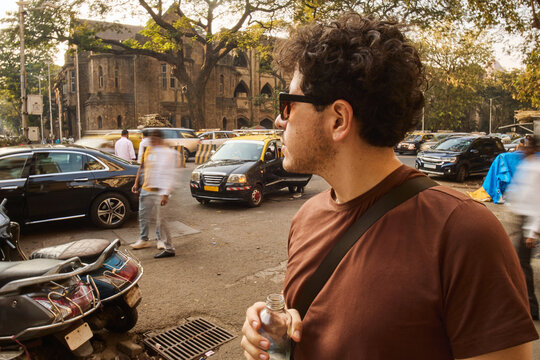 Man standing on street corner in Mumbai