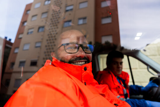 Portrait of a paramedic through glass