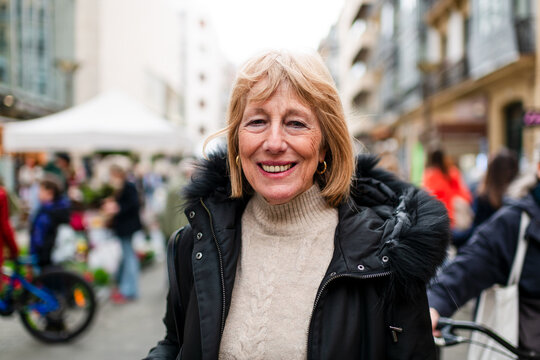 Happy senior woman on flea market street