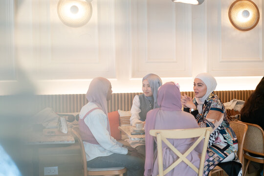 Hijabi Muslim Women Having Coffee