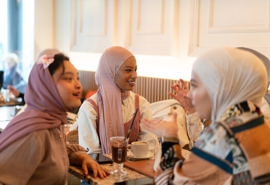 Hijabi Muslim Women Having Coffee