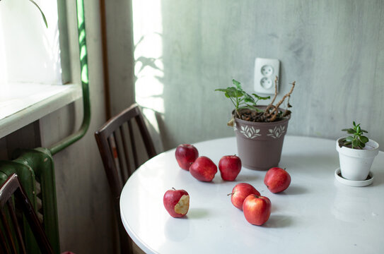red apples lie on a white table