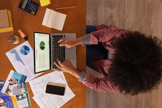 Woman analyzing financial data on laptop