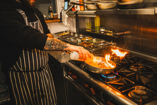Chef Cooking with Flames on Stove