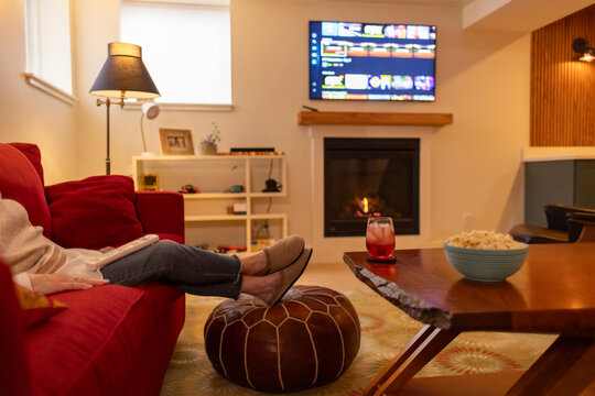 Senior Citizen Streaming tv content at home cozy living room 