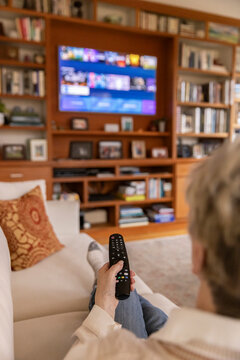 Senior citizen watch tv at home remote control comfortable  