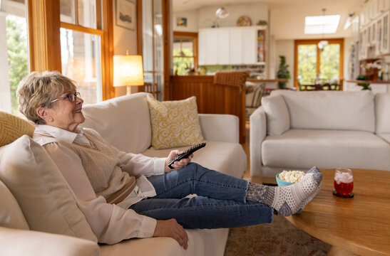 Senior citizen watching television at home 