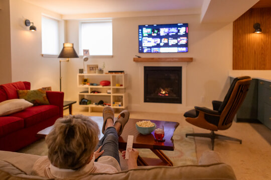 Senior citizen watch tv at contemporary  home alone