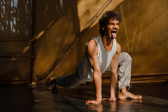 Man Performing Lion's Breath Yoga Pose for Energy Release