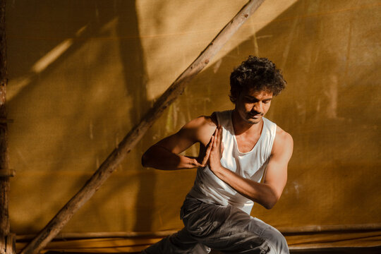 Man in Revolved Lunge Pose Performing Prayer Twist Yoga