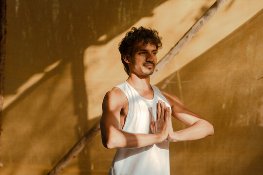 Man Standing in Namaste Pose Embracing Calm and Focus