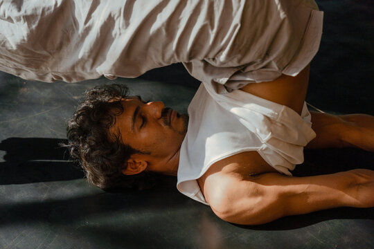 Man in Shoulder Stand Yoga Pose with Focused Expression