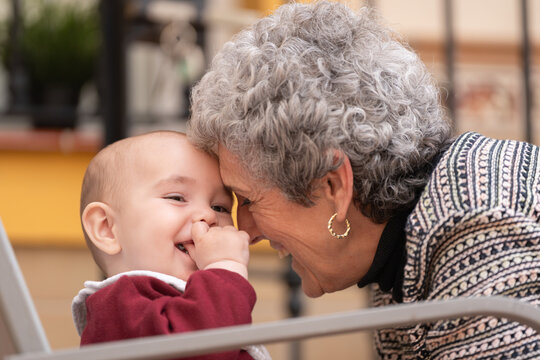 Portrait of a grandmother caressing her grandson