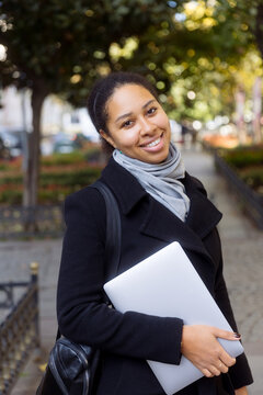 Portrait of a young woman with a laptop in her hands