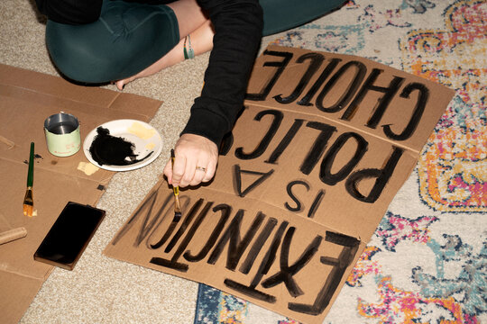 Painting a Protest Sign for Environmental Justice
