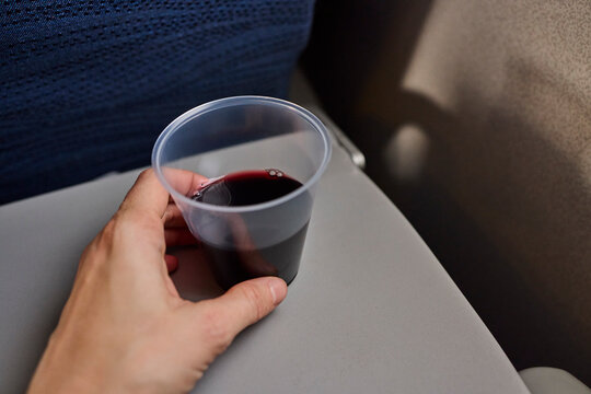 Woman drinking wine during flight