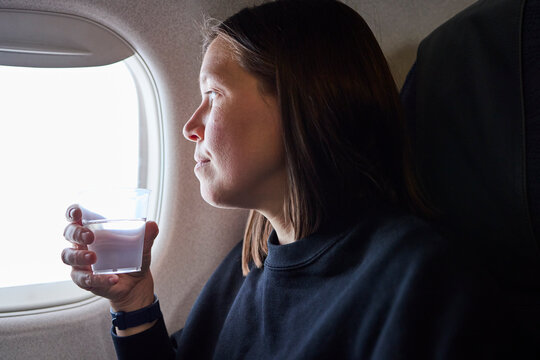 Woman drinking water during flight