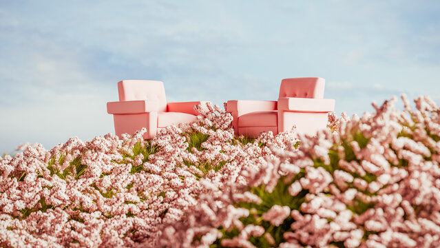 Two pink armchairs placed on a hill surrounded by blooming flowers