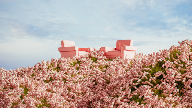 Two pink armchairs placed on a hill surrounded by blooming flowers