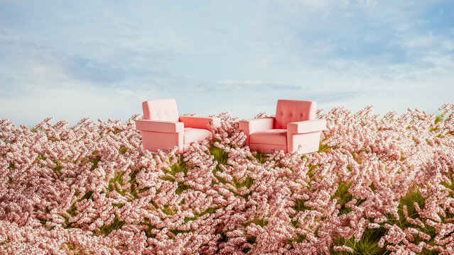 Two pink armchairs placed on a hill surrounded by blooming flowers