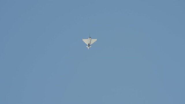 LUQA, MALTA - SEPTEMBER 28, 2025: A Eurofighter Typhoon flies in a clear blue sky before visually morphing into a different aircraft, an L-39 trainer jet. A concept of transformation and technology.