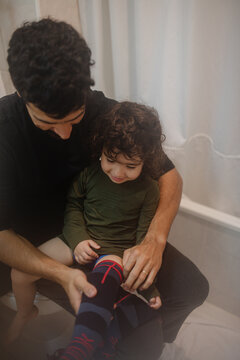 Father dressing his son