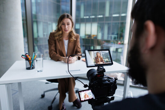 Businesswoman recording video for company's social media at office
