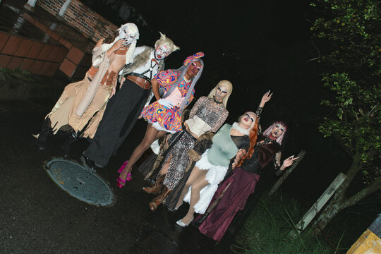 Group of drag queens posing outdoors 