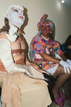 Two drag queens in colorful dresses 