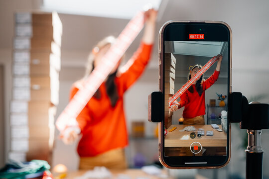 A person displays fragile tape in front of smartphone camera